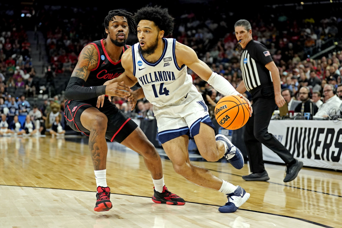 Mar 26, 2022; San Antonio, TX, USA; Villanova Wildcats guard Caleb Daniels (14) drives to the basket against Houston Cougars forward J'Wan Roberts (13) during the first half in the finals of the South regional of the men's college basketball NCAA Tournament at AT&T Center. Mandatory Credit: Scott Wachter-USA TODAY Sports